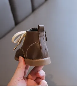 Close-up of brown leather baby boot heel showing stitching and soft sole detail.