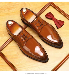 Detail of polished brown leather men's Derby shoes with pointed toe and thick sole