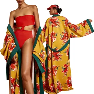 Copricostume kimono a fiori con un costume da bagno rosso a vita alta su modella pro