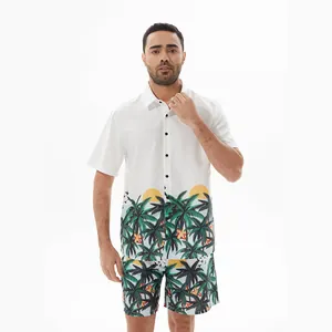 Male model wearing white Hawaiian shirt and matching tropical print beach shorts set