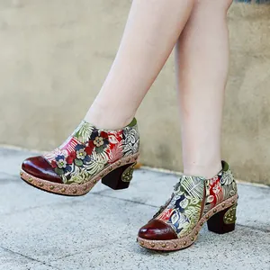 Detail view of vintage floral leather heels with 3D flower accents and chunky heels