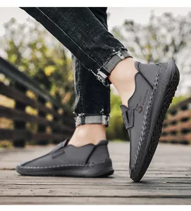 Gedetailleerd overzicht van grijze leren herenloafers met handgemaakte stiksels