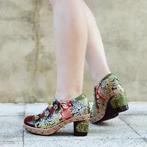 Side view of vintage floral leather pumps with 3D flower details and chunky heels