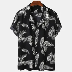 Detail of black Hawaiian shirt featuring white palm leaf print and lapel collar
