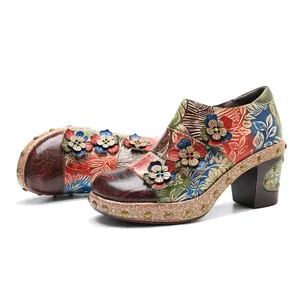 Detailed macro view of colorful vintage floral leather shoes with 3D flower accents