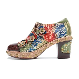 Side view of vintage handmade leather high heel shoe with 3D floral accents and studs
