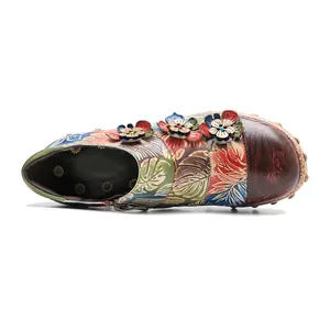 Detailed top view of vintage leather high heels with colorful floral hand-painted patterns