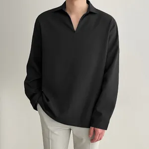 Detail view of men's loose V-neck long sleeve shirt in black with smooth drape