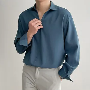 Detail view of a men's loose V-neck pullover shirt in teal with smooth drape fabric