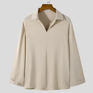 Modern men's loose V-neck long sleeve shirt in beige with a smooth draped fabric