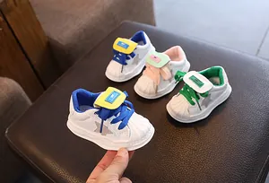 Detailed view of colorful baby shell-toe sneakers featuring leather upper and star design