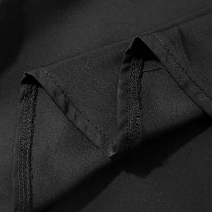 Close-up of fine stitching and black textured fabric on a men's loose casual fashion shirt.