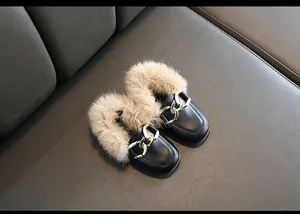 Detailaufnahme von Mädchen-Loafers mit Pelzbesatz und goldener Kettenschnalle