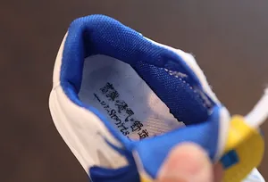 Detail of breathable blue mesh lining and insole of kids' white leather board shoes