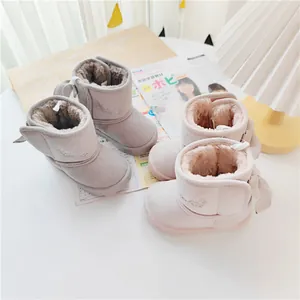 Detailed view of plush faux fur lining and cute bow on children's snow boots