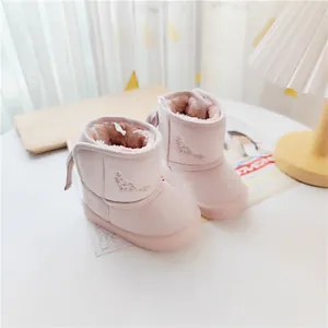 Warm pink children's winter snow boots with a stylish large bow and soft faux fur lining