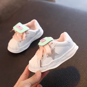 Stylish children's shell-toe white sneakers with star patch and pink laces