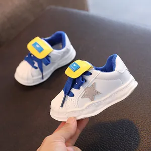 Fashionable kids' white sneakers featuring a star pattern and a durable rubber sole