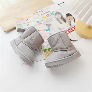 Detail view of gray toddler snow boots with delicate leaf embroidery and thick sole