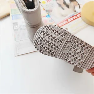 Close-up detail of anti-slip wavy patterned sole on grey winter children snow boots.