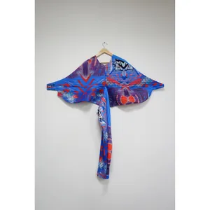 Vista detallada del estampado abstracto en un vestido plisado con mangas de murciélago