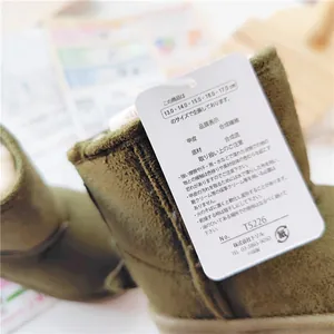 Close-up of product tag on olive green children's winter snow boots