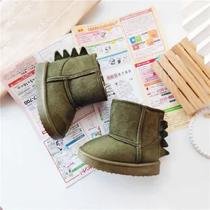 Detail view of green dinosaur children's snow boots with soft plush lining for winter.