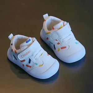 Detailed view of white breathable leather baby walking shoes with colorful confetti patterns.