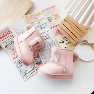 Detailed view of pink toddler winter snow boots with soft fur lining and bow detail.