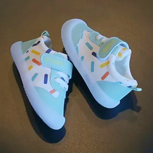Detail view of breathable leather toddler walking shoes with colorful dot patterns and velcro straps