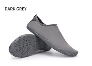Primo piano di scarpe da scoglio grigio scuro con suole flessibili per nuoto e attività all'aperto.