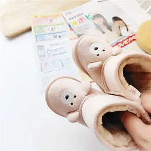 Close-up of cute cartoon bear baby snow boots with thick warm fuzzy lining