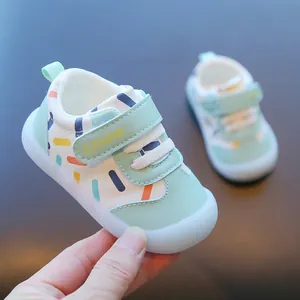 Detail of breathable mint green baby walking shoes with colorful dash patterns