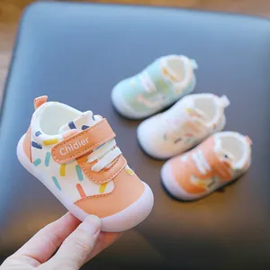 Close-up view of breathable leather baby walking shoes with colorful confetti pattern