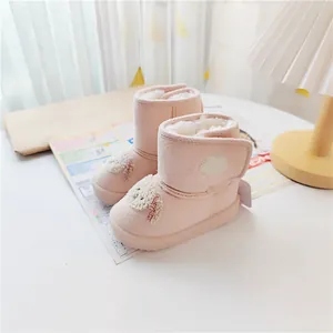 Close-up of pink toddler snow boots featuring cute cartoon puppy design and warm fleece lining