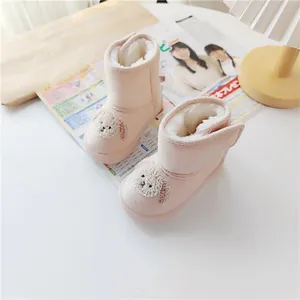 Detail of pink toddler snow boots with plush bunny ears and warm faux fur lining