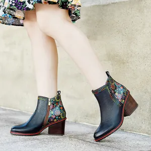 Close-up of retro patchwork leather ankle boots with floral patterns and chunky heels