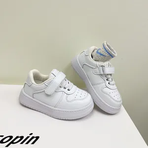 Macro view of white toddler walking shoes with soft soles for boys aged 1-3 years