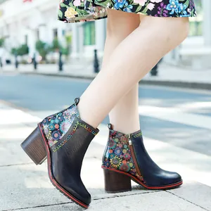 Detail shot of vintage genuine leather ankle boots featuring floral patterns and chunky heels