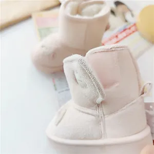 Detail view of pink children's snow boots with soft plush lining and velcro strap