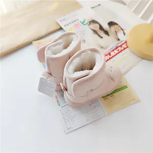 Top view of pink cartoon children's snow boots with thick warm fleece lining and velcro