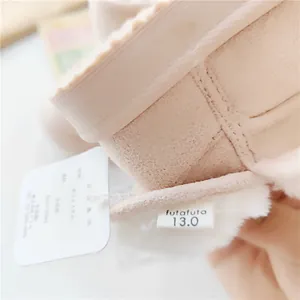 Detail view of futafuta children's winter snow boots showing the size label and tag