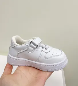 Close-up of white toddler sneaker with hook and loop strap and soft sole display