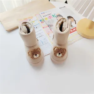 Beige children's snow boots featuring a cute cartoon bear and warm faux fur lining.
