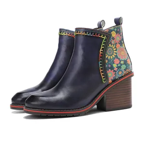 Side view of vintage navy blue leather ankle boots with floral patchwork and chunky heel