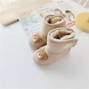 Detail view of cute cartoon bear snow boots with thick warm faux fur lining for kids