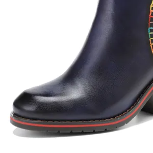 Macro view of hand-rubbed genuine leather ankle boot with colorful stitching detail