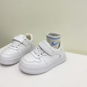 Toddler boys' white leather sneakers with soft soles and dual hook and loop straps