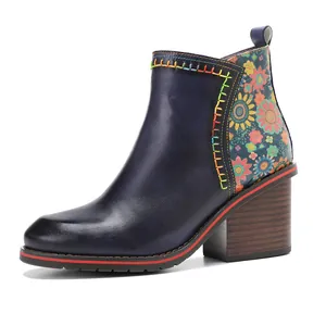Side view of retro leather ankle boots with floral pattern and chunky wood heel