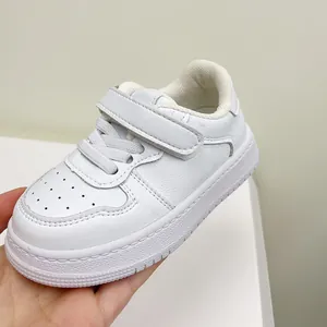 Classic white toddler walking shoes with soft sole and hook-and-loop closure